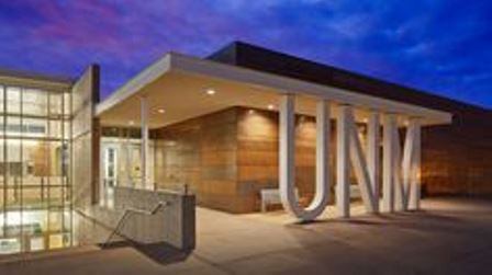 large unm letters in front of a building